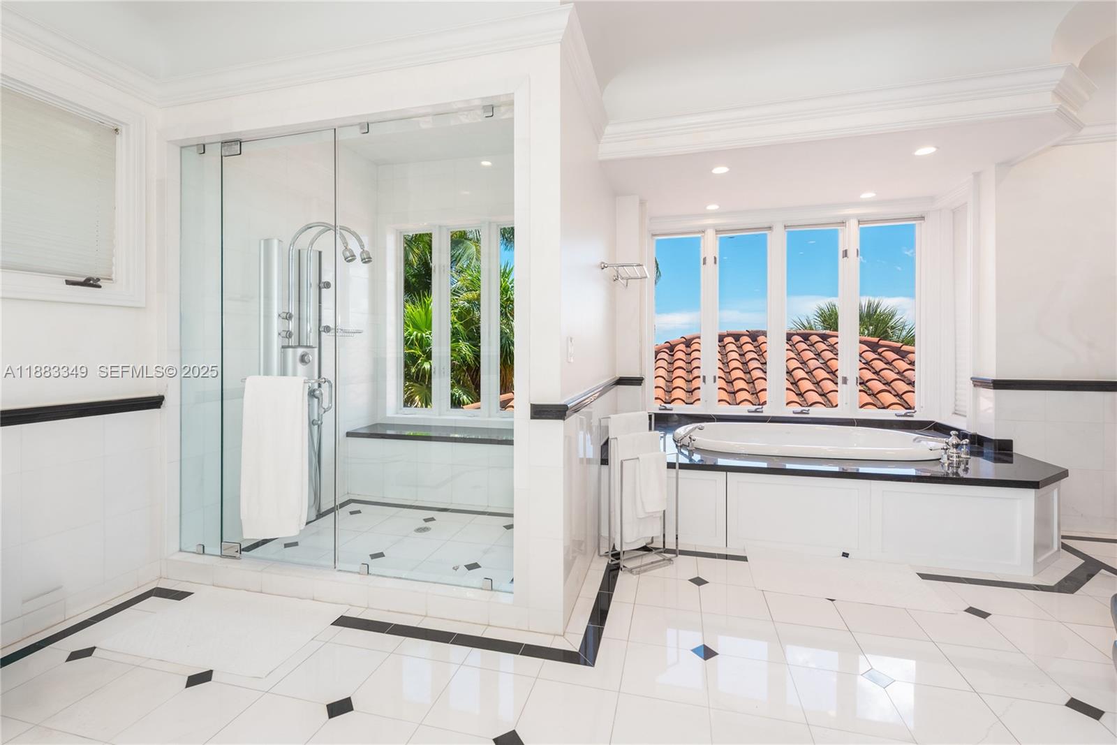 260 Cape Florida Drive Key Biscayne, FL 33149 - Photo 15 of 24 a bathroom with a tub sink and mirror