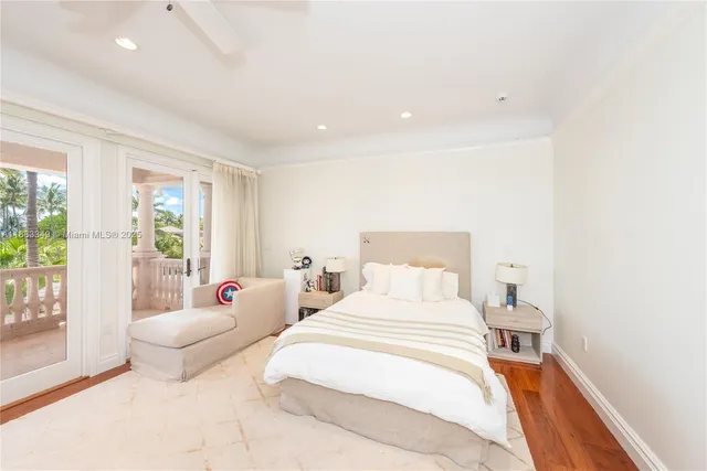 a bedroom with a bed and large windows