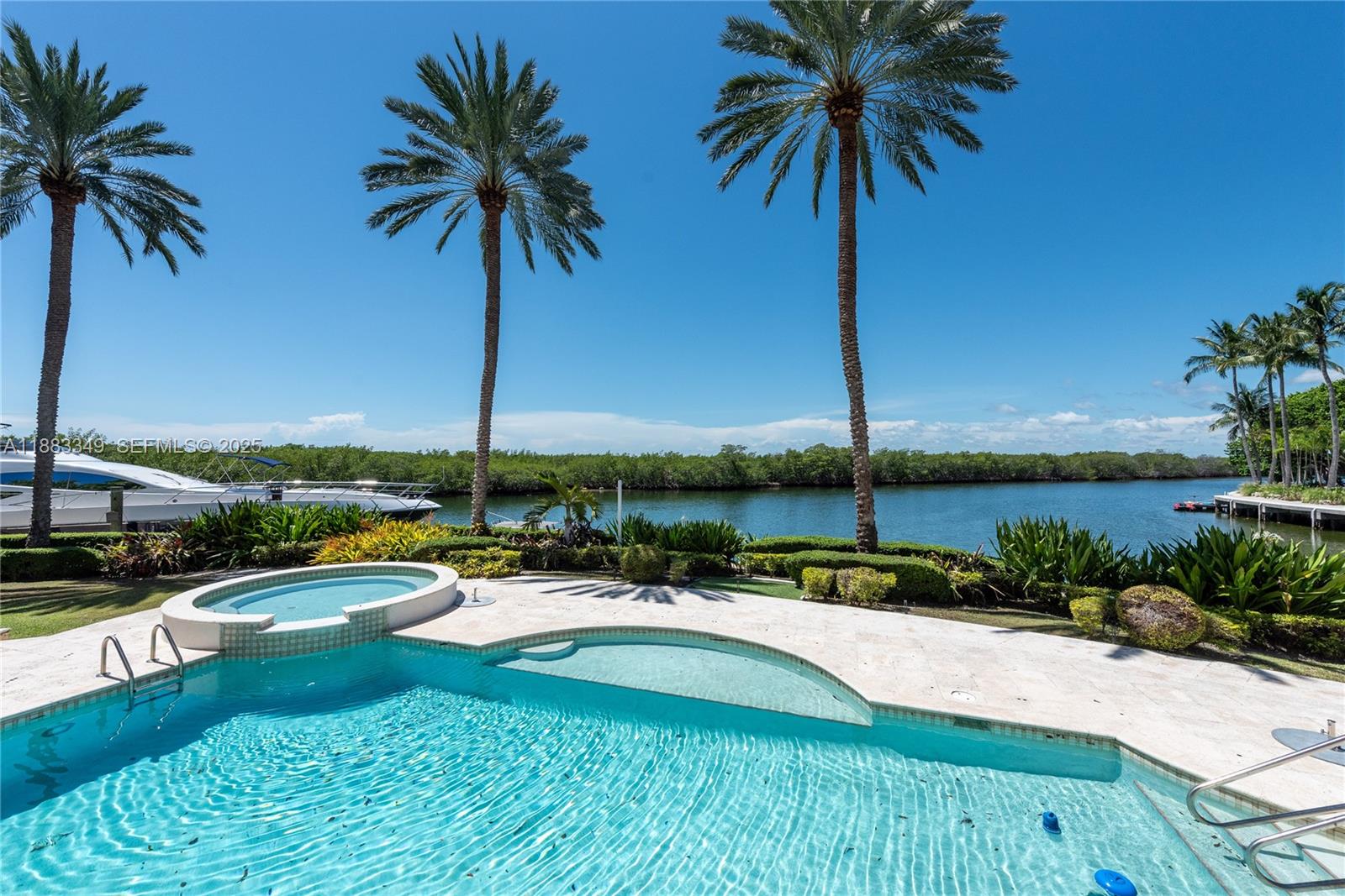 260 Cape Florida Drive Key Biscayne, FL 33149 - Photo 22 of 24 a view of swimming pool with a table and chairs
