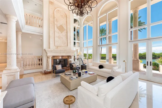 a living room with patio fireplace furniture and a large window