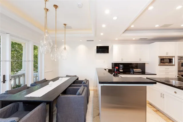 a kitchen with a table chairs stove and microwave