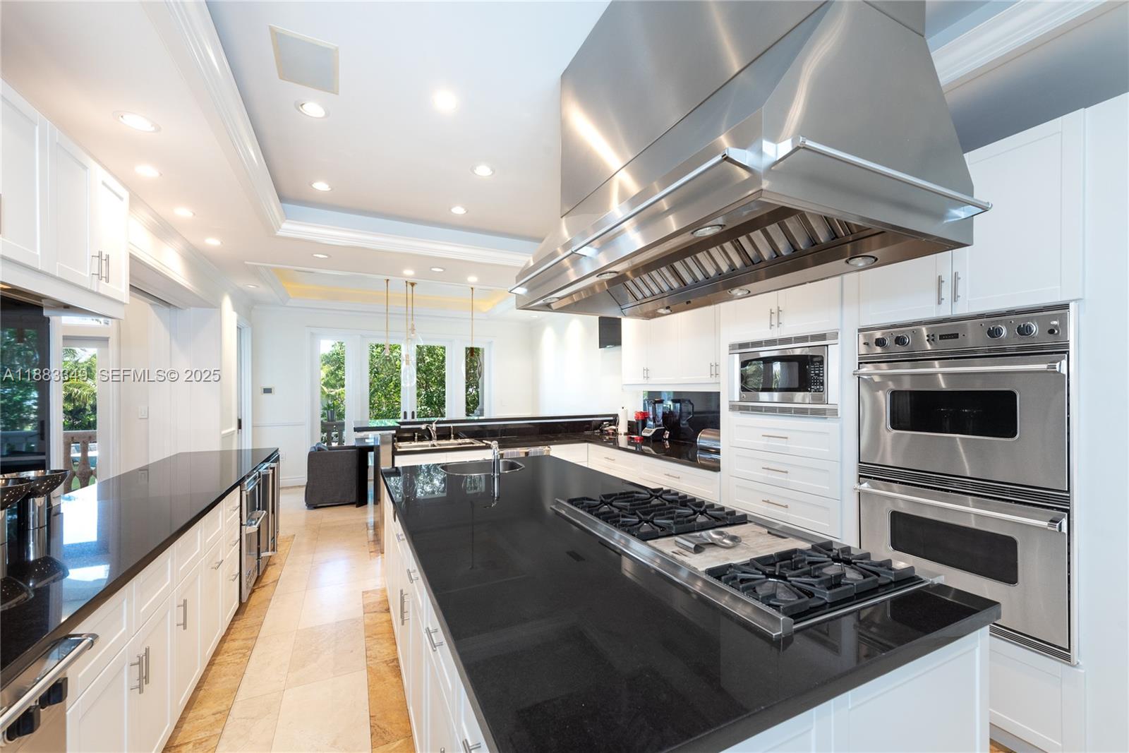 260 Cape Florida Drive Key Biscayne, FL 33149 - Photo 8 of 24 a living room with stainless steel appliances kitchen island granite countertop a stove and a sink