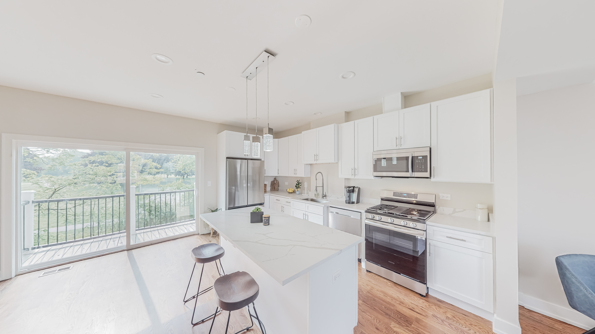 521 Highlands Parkway Itasca, IL 60143 - Photo 5 of 22 a open kitchen with white cabinets a stove and a large window