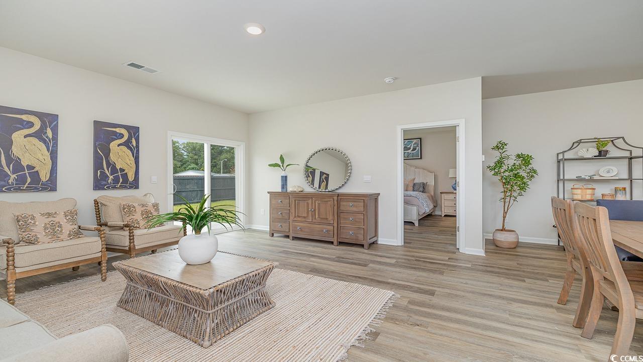 303 Ridley Street Longs, SC 29568 - Photo 11 of 31 Living area featuring light wood-style floors and baseboards