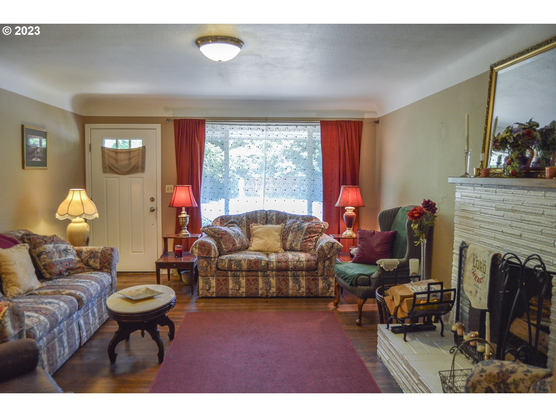 367 Hayden Bridge Way Springfield, OR 97477 - Photo 5 of 16 a living room with furniture a window and a fireplace