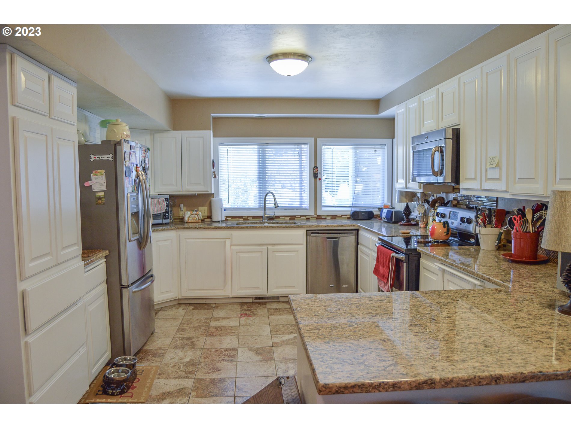 367 Hayden Bridge Way Springfield, OR 97477 - Photo 6 of 16 a kitchen with stainless steel appliances granite countertop a refrigerator sink and cabinets