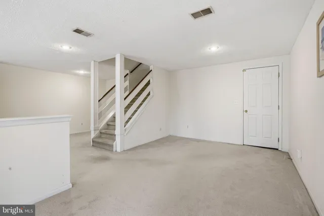 a view of an empty room with stairs