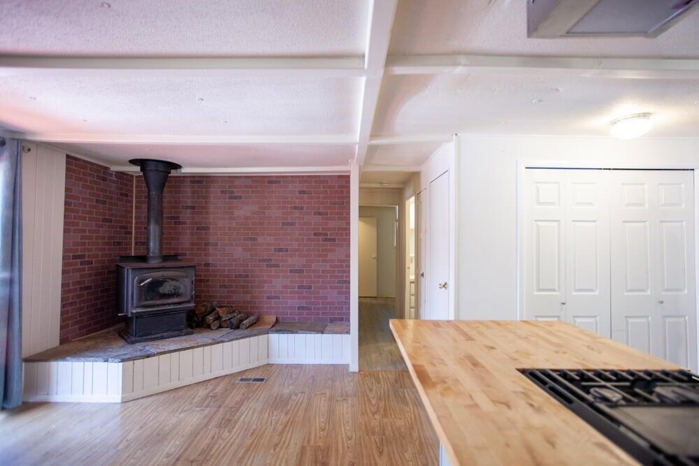 4778 North River Road Gold Hill, OR 97525 - Photo 5 of 15 a view of a hallway with wooden floor and staircase