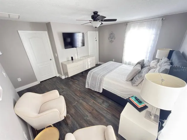 a bedroom with a bed and a flat screen tv