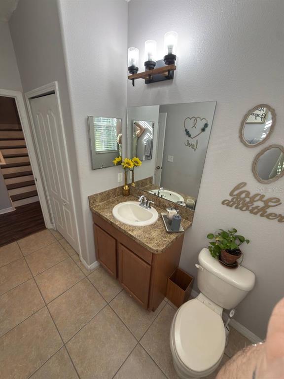 1277 Seburn Road Apopka, FL 32703 - Photo 20 of 28 a bathroom with a sink vanity mirror and toilet