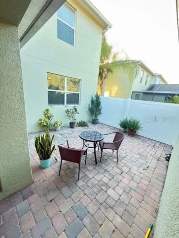 a backyard of a house with table and chairs