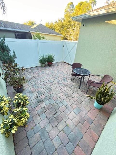1277 Seburn Road Apopka, FL 32703 - Photo 22 of 28 a view of a chairs and table in backyard