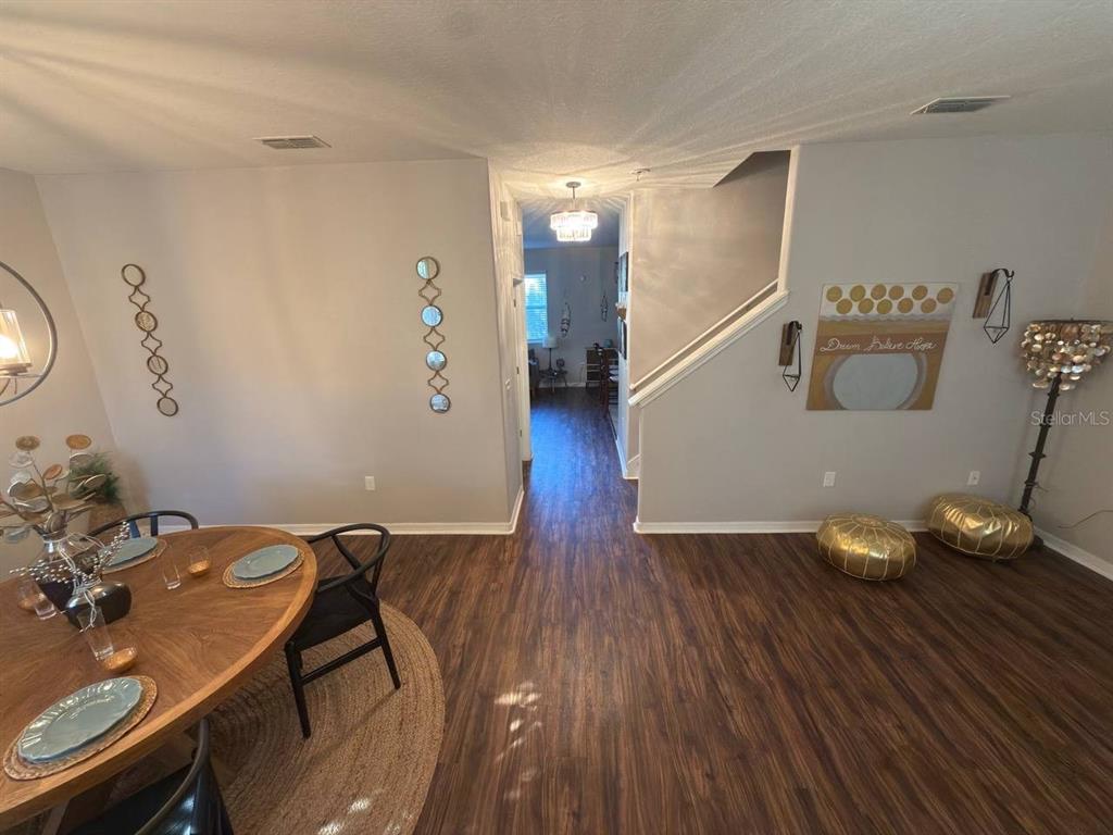 1277 Seburn Road Apopka, FL 32703 - Photo 10 of 28 a view of a dining room with furniture and wooden floor