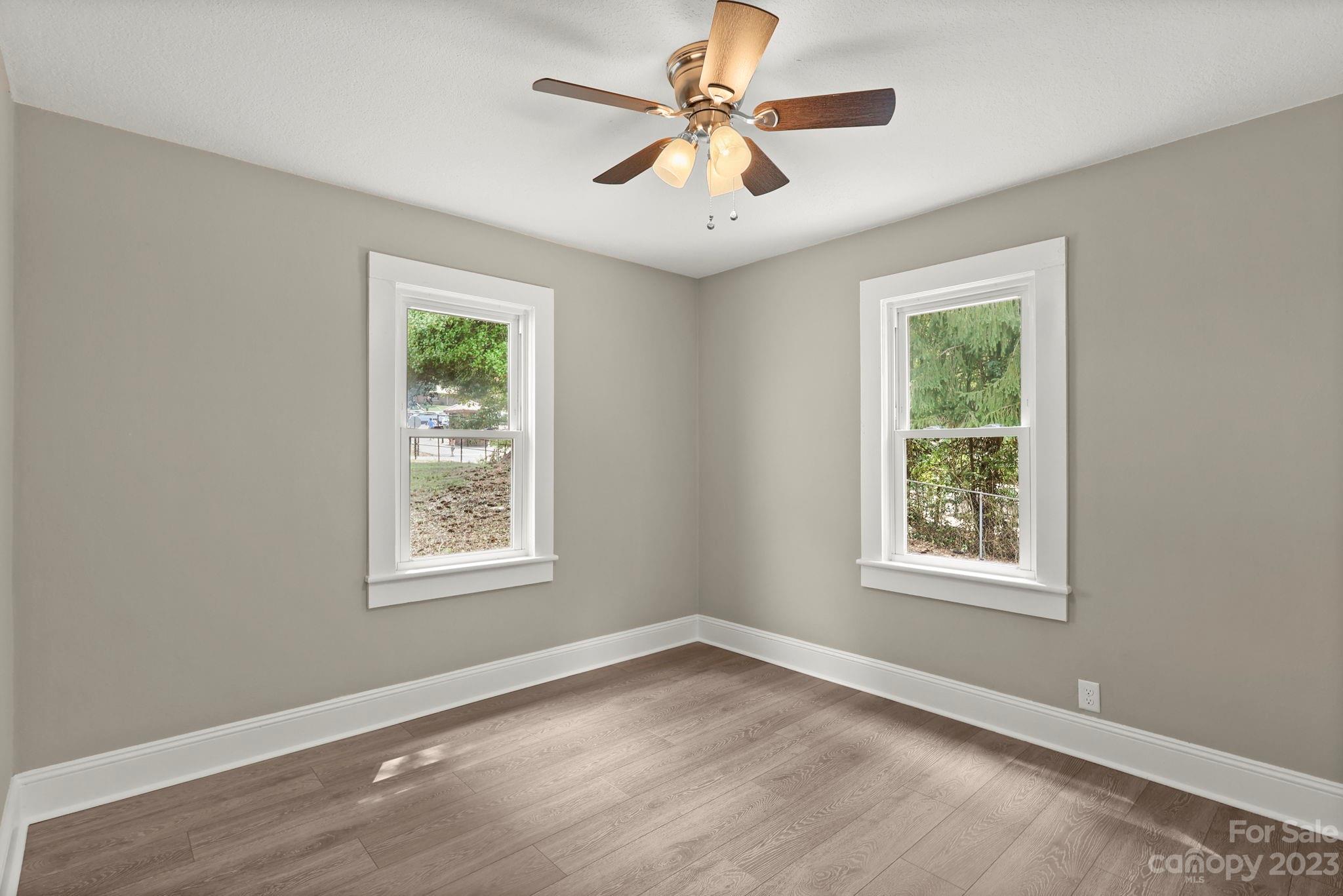 185 Substation Road Canton, NC 28716 - Photo 12 of 32 a view of an empty room with a window and a chandelier fan