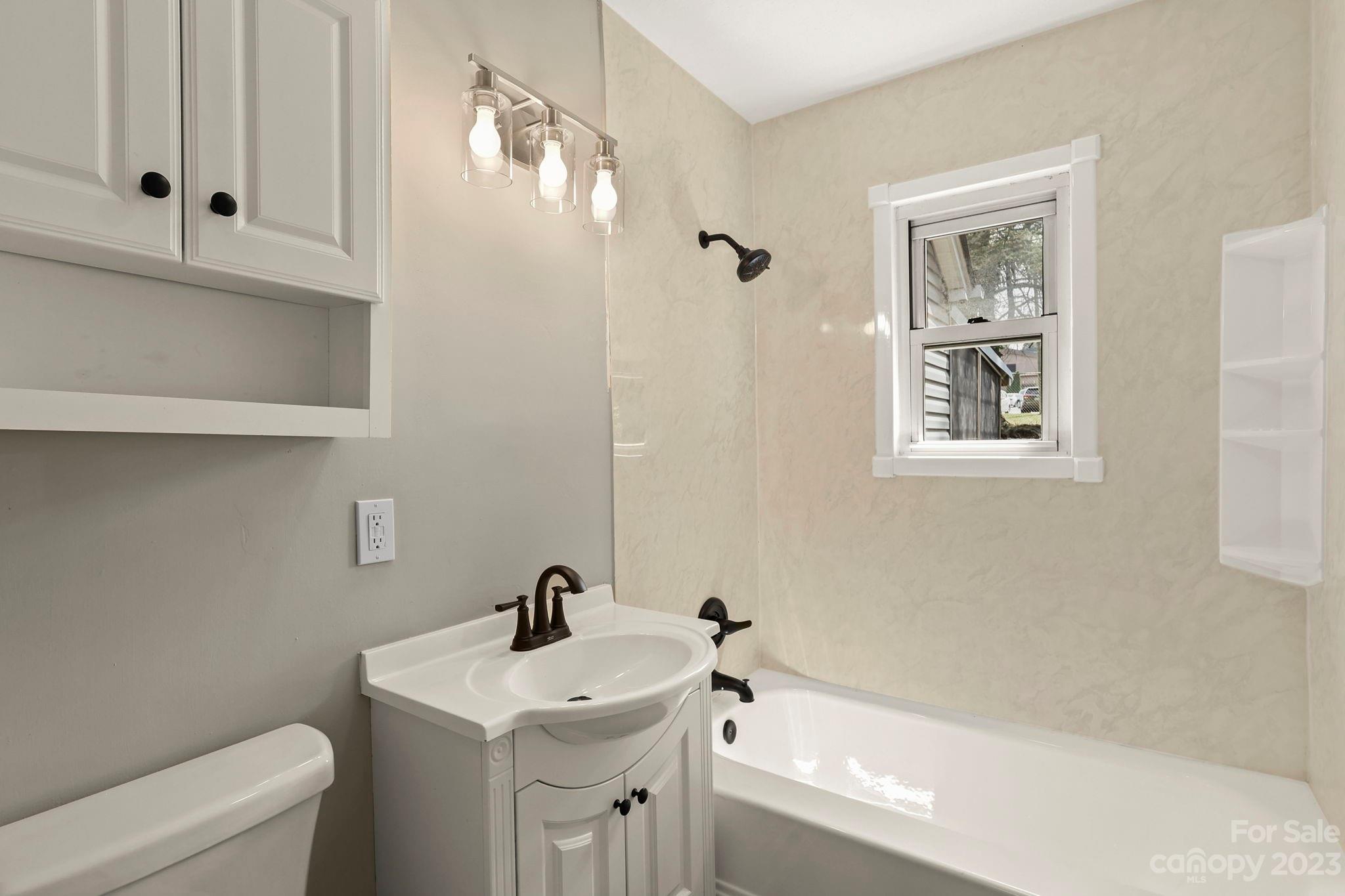 185 Substation Road Canton, NC 28716 - Photo 14 of 32 a bathroom with a sink a toilet and shower