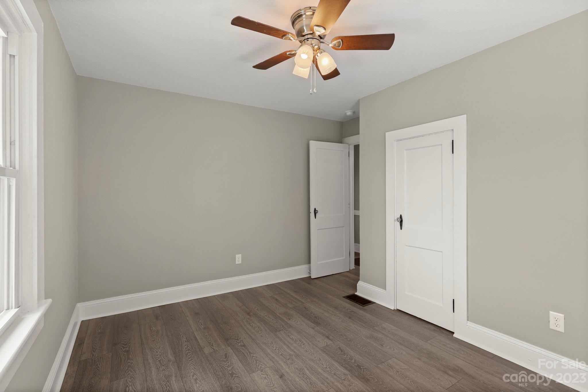 185 Substation Road Canton, NC 28716 - Photo 16 of 32 a view of a room with wooden floor and a ceiling fan