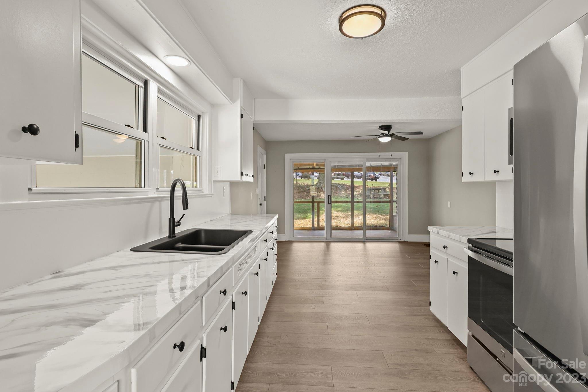 185 Substation Road Canton, NC 28716 - Photo 17 of 32 a kitchen with stainless steel appliances granite countertop a sink and a stove