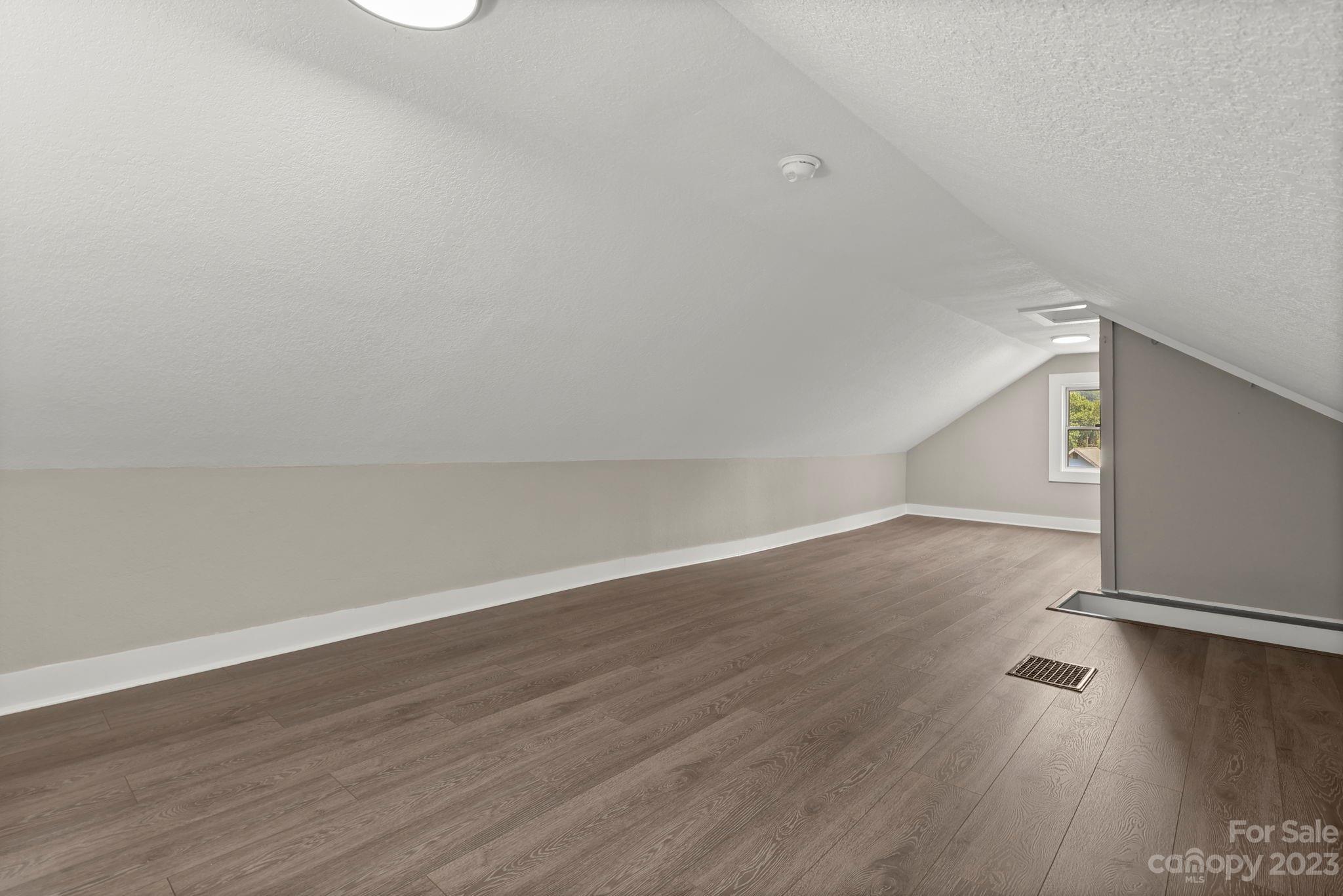 185 Substation Road Canton, NC 28716 - Photo 20 of 32 a view of an empty room with wooden floor