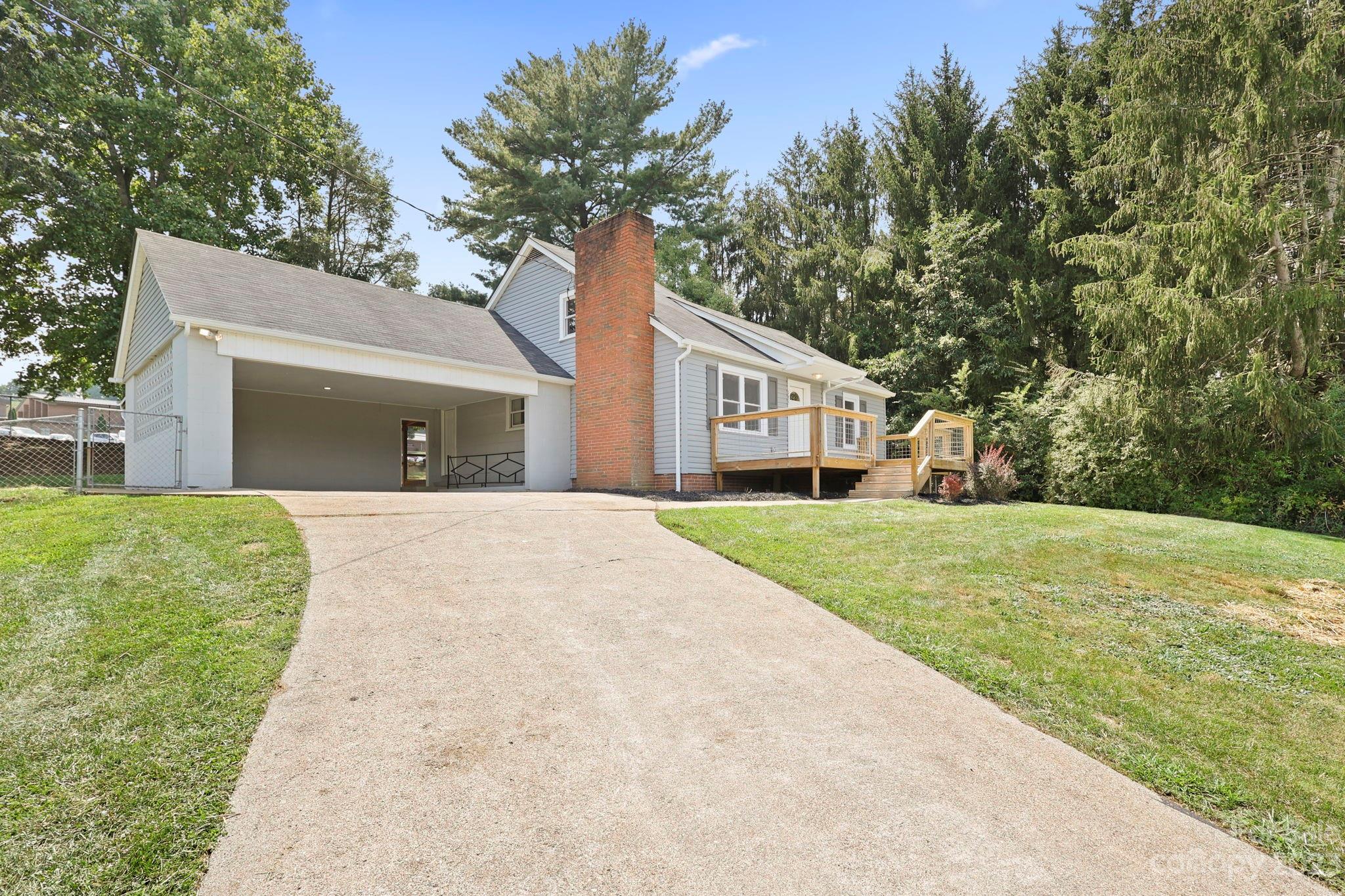 185 Substation Road Canton, NC 28716 - Photo 2 of 32 a front view of a house with yard and tree s