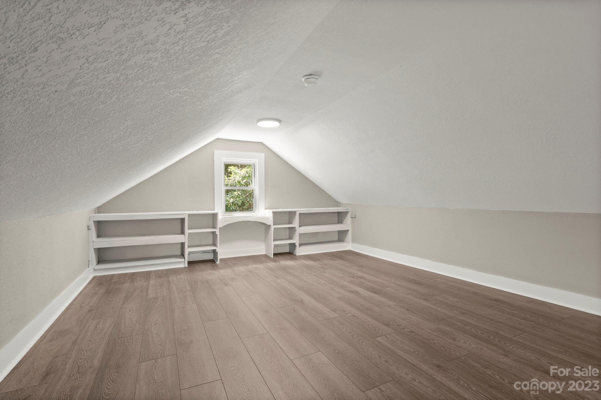 185 Substation Road Canton, NC 28716 - Photo 21 of 32 an empty room with wooden floor and white walls