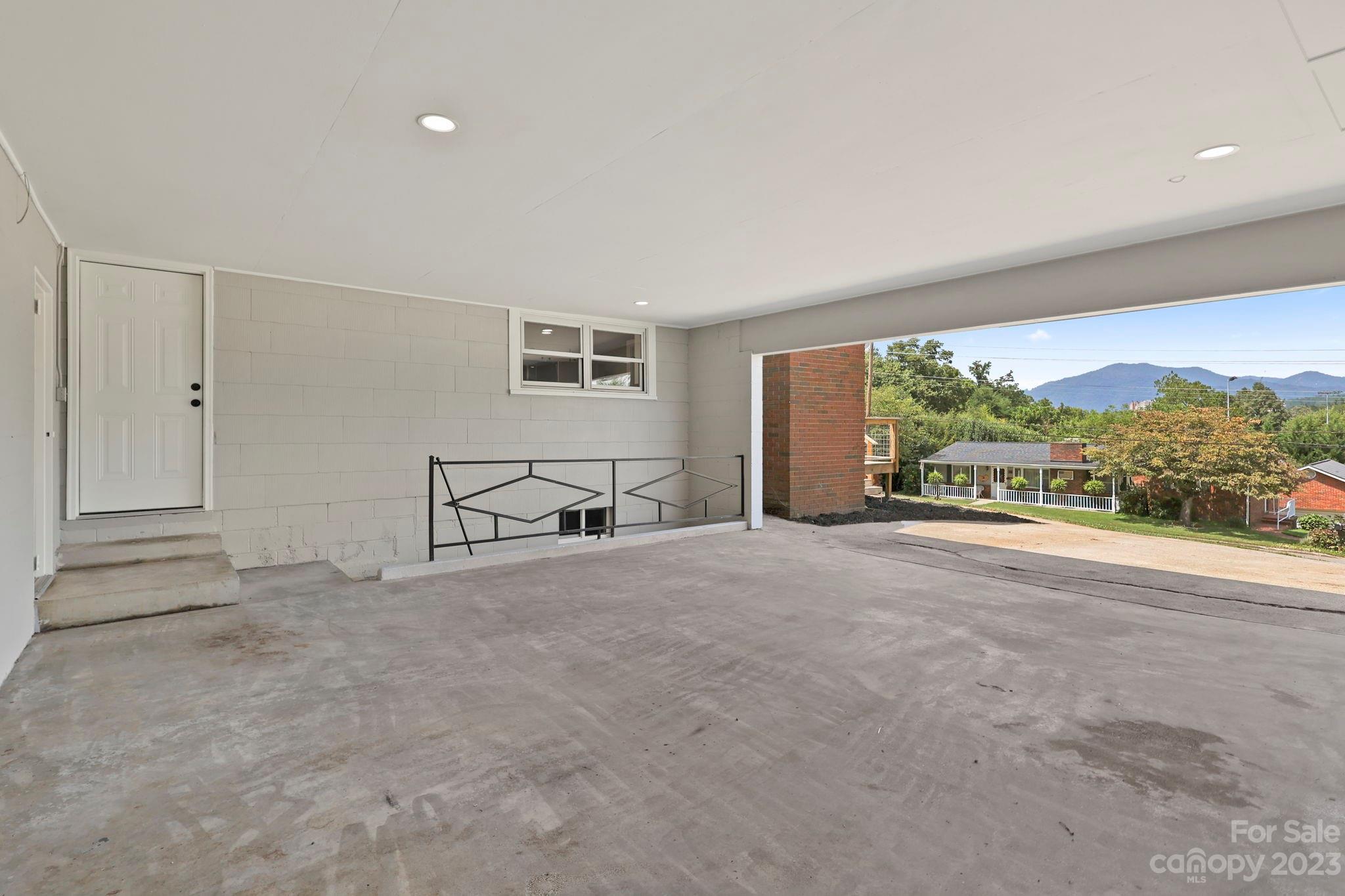185 Substation Road Canton, NC 28716 - Photo 27 of 32 a view of an empty room with a window and refrigerator