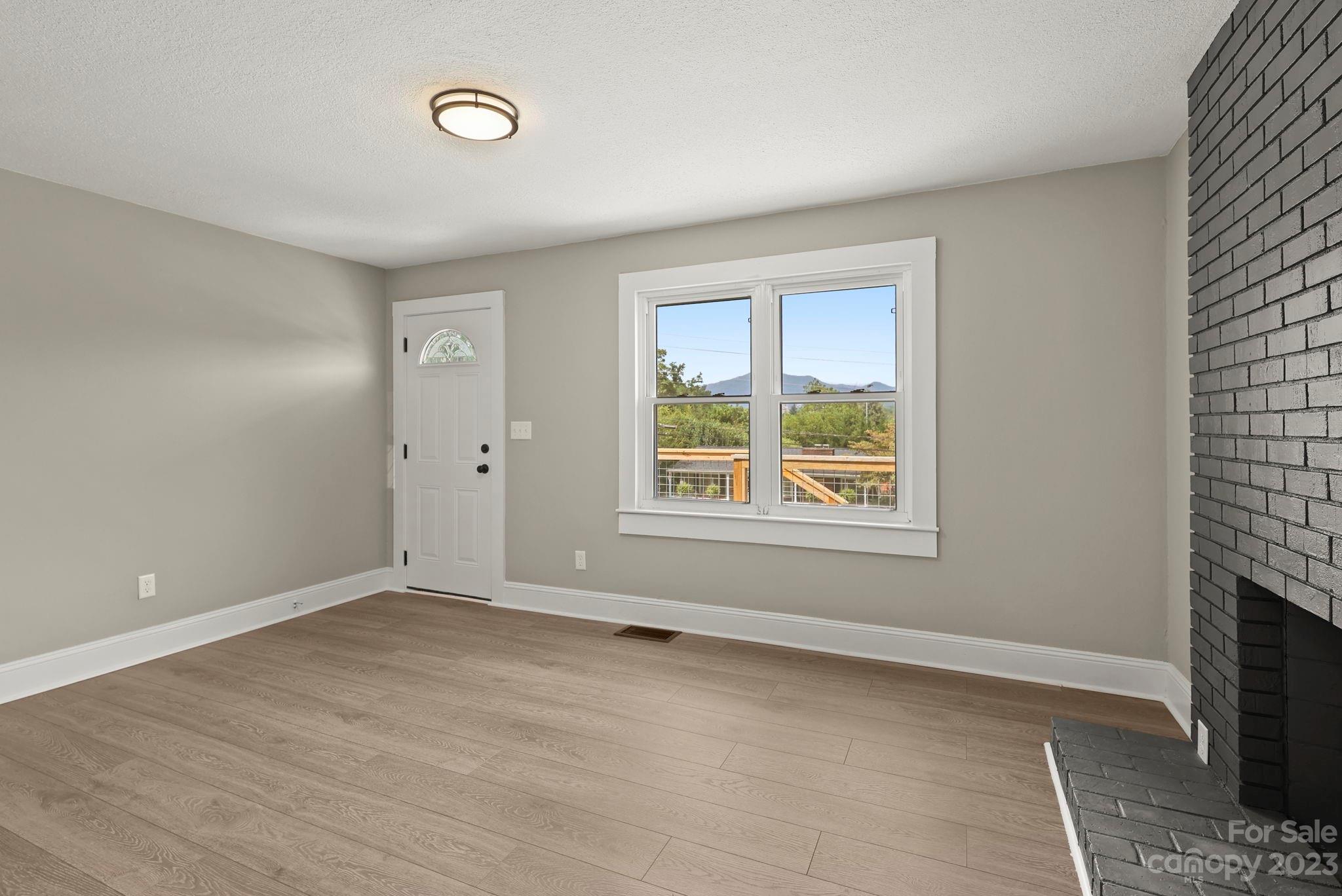 185 Substation Road Canton, NC 28716 - Photo 7 of 32 a view of an empty room with a window