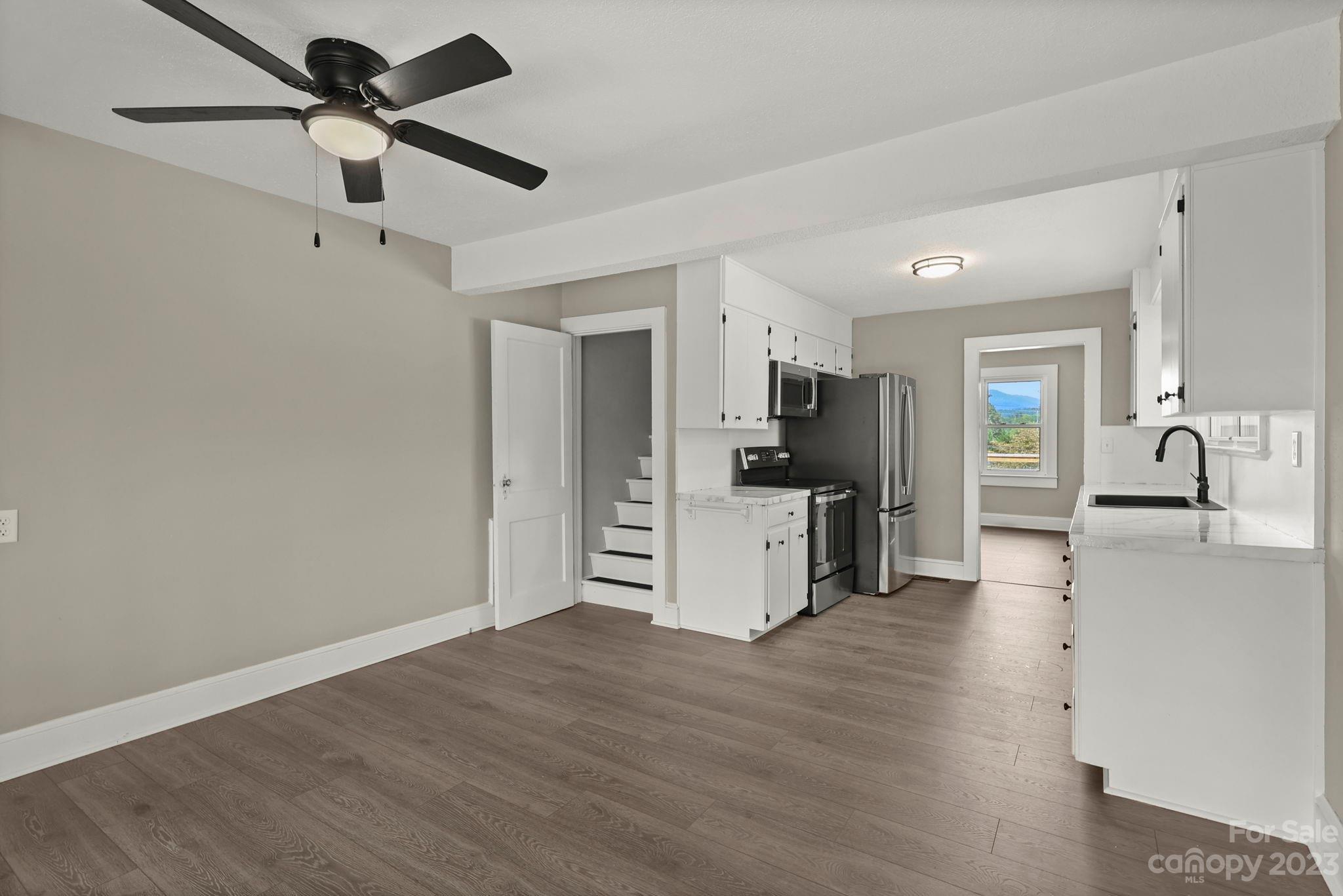 185 Substation Road Canton, NC 28716 - Photo 8 of 32 a view of a kitchen with a sink and a refrigerator