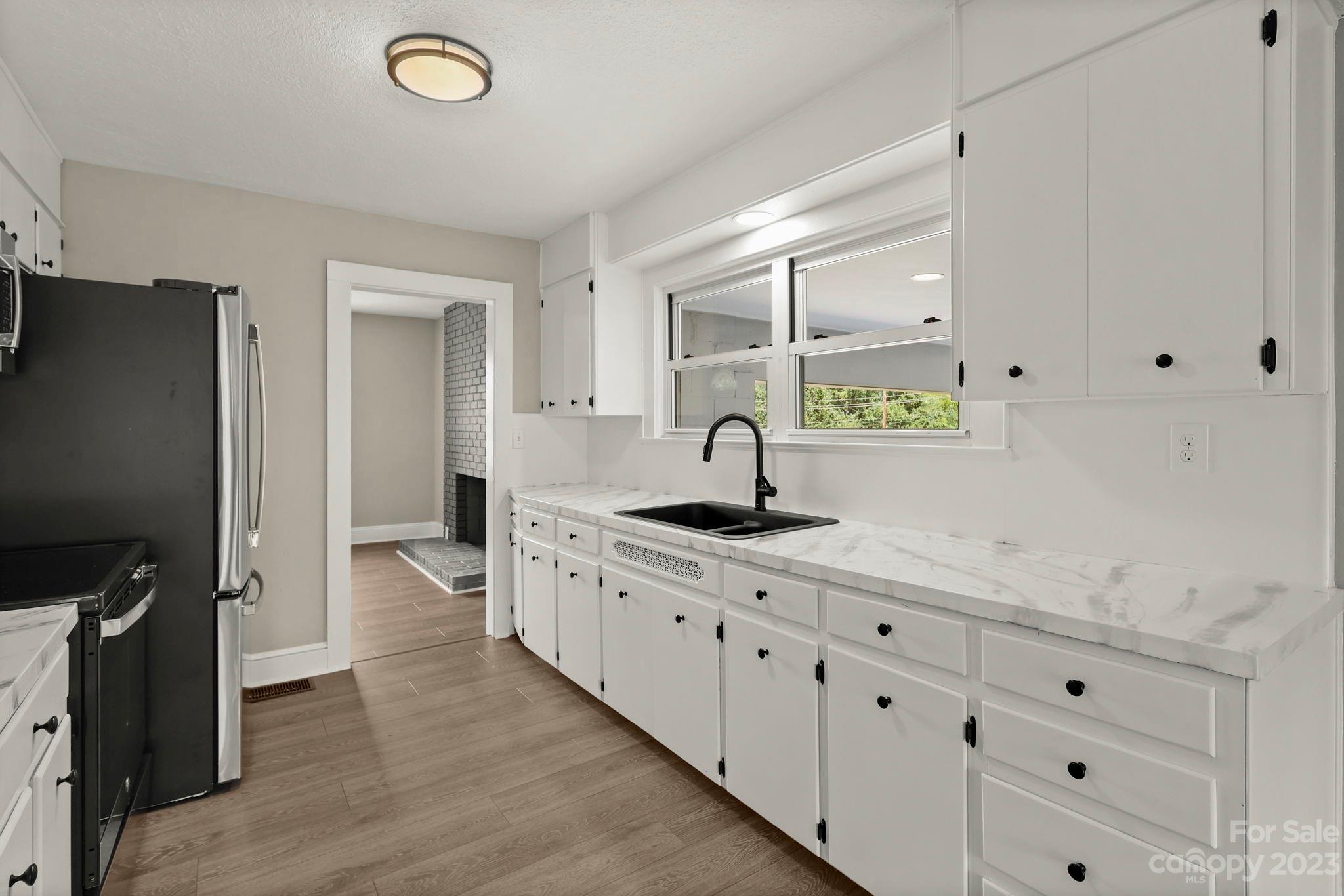 185 Substation Road Canton, NC 28716 - Photo 10 of 32 a kitchen with a sink appliances and cabinets