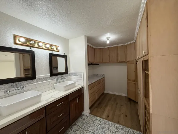 a bathroom with a sink a large mirror and a shower