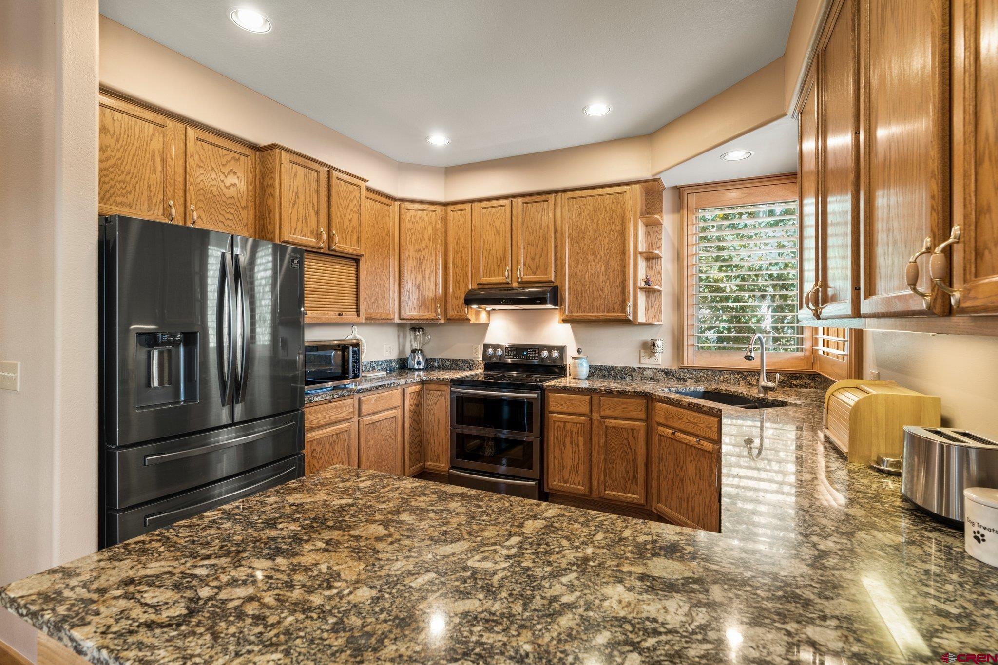 60 Edgemont Way Durango, CO 81301 - Photo 12 of 35 a kitchen with stainless steel appliances granite countertop a refrigerator stove and sink
