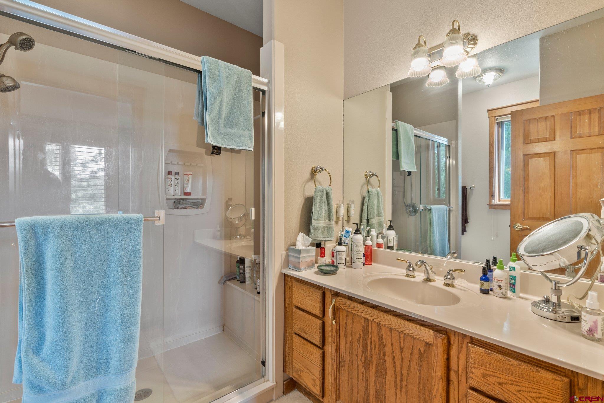 60 Edgemont Way Durango, CO 81301 - Photo 16 of 35 a bathroom with a double vanity sink mirror and shower