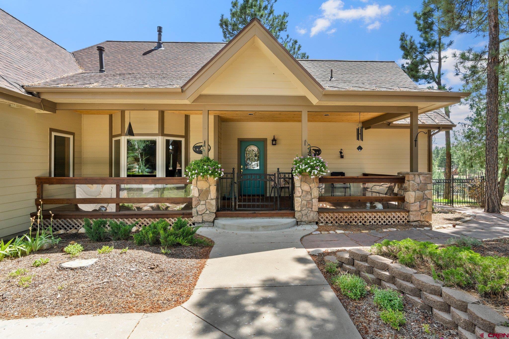 60 Edgemont Way Durango, CO 81301 - Photo 28 of 35 a view of a house with entrance door and a yard