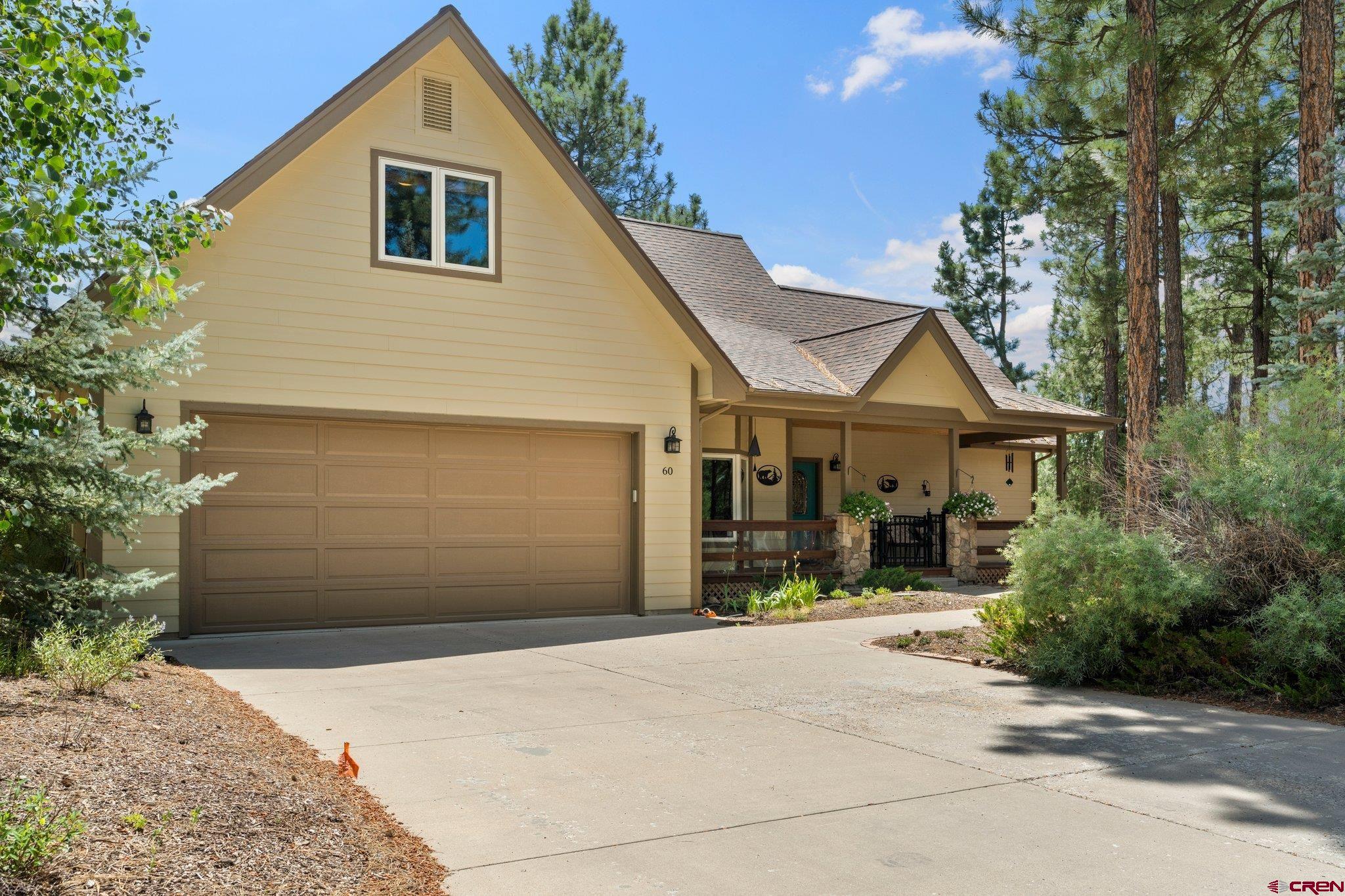60 Edgemont Way Durango, CO 81301 - Photo 29 of 35 a front view of a house with a yard and garage