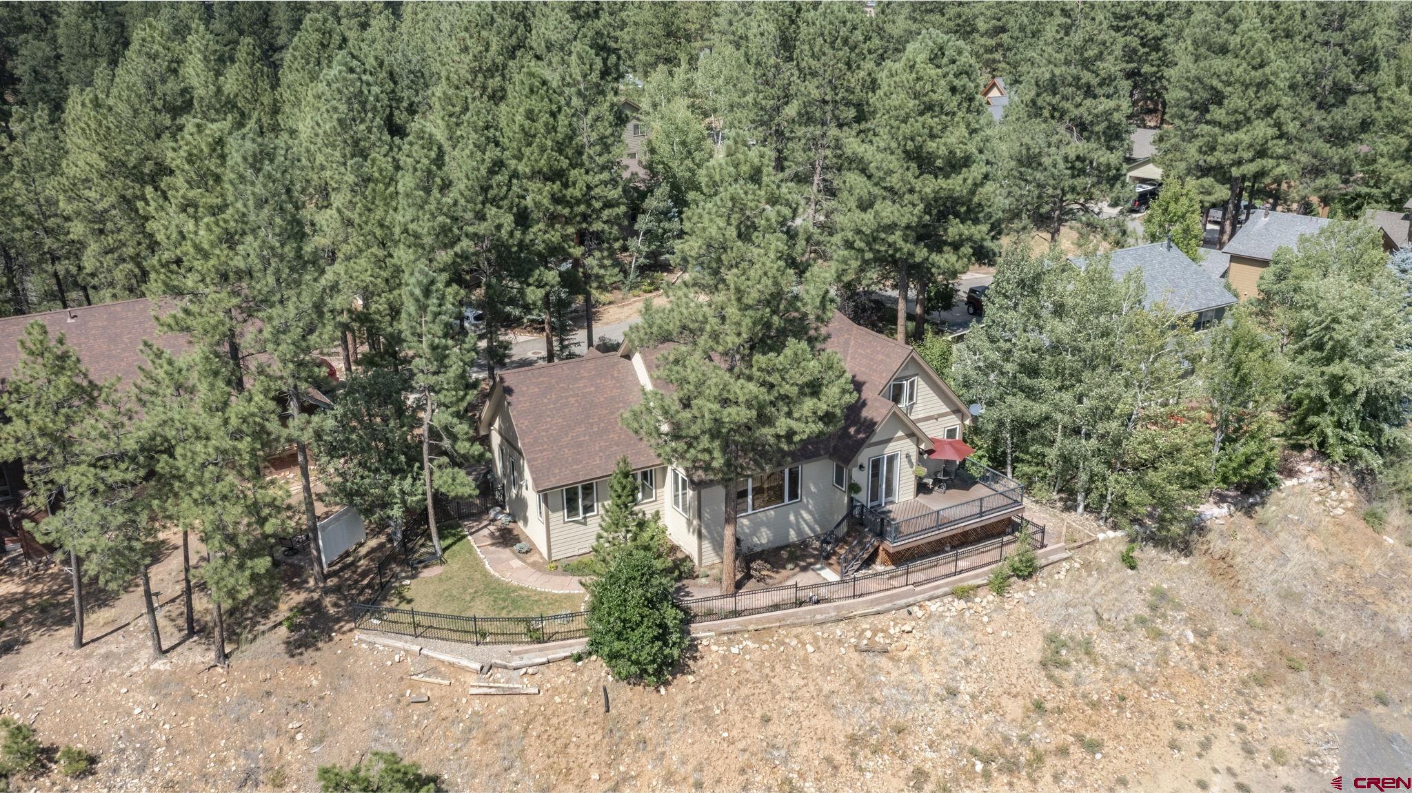 60 Edgemont Way Durango, CO 81301 - Photo 34 of 35 an aerial view of a house with a yard and large trees