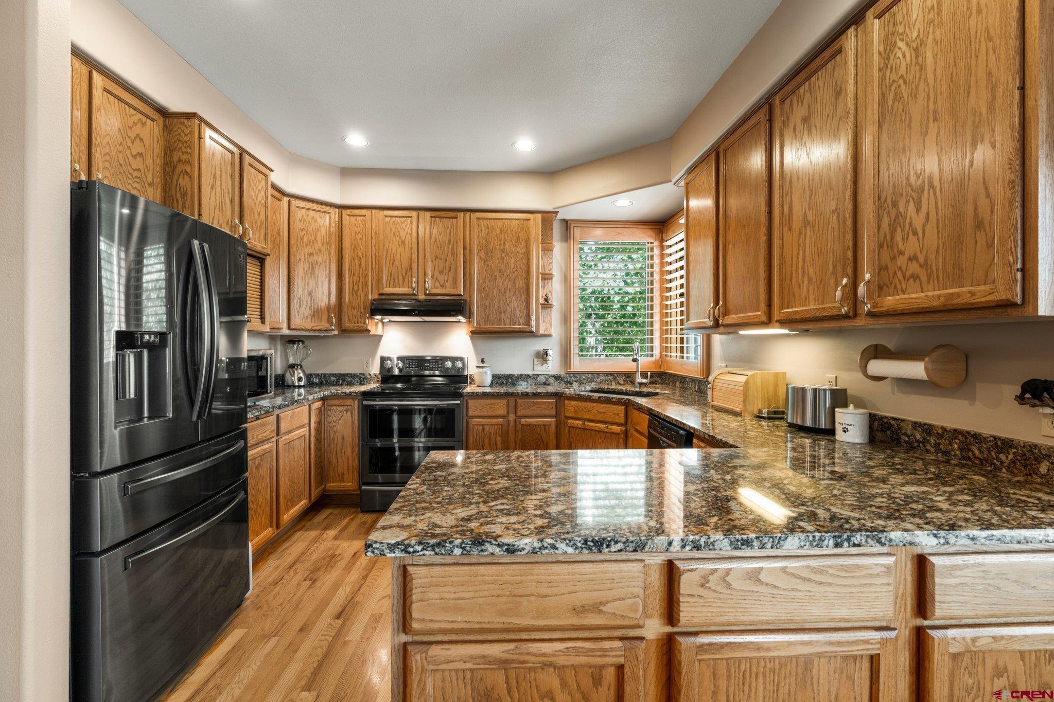 60 Edgemont Way Durango, CO 81301 - Photo 10 of 35 a kitchen with kitchen island granite countertop a refrigerator stove and sink