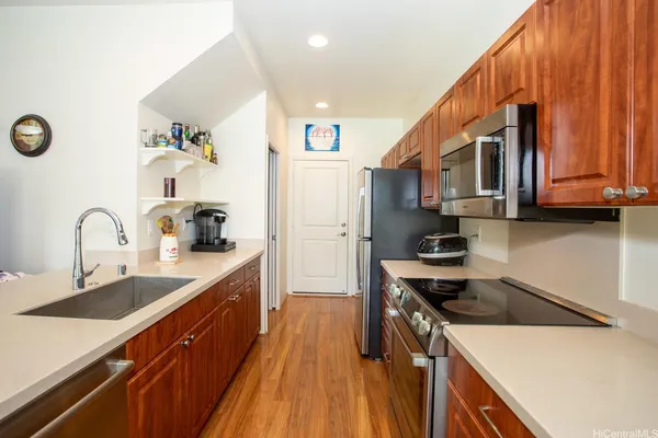 a kitchen with stainless steel appliances a sink stove and cabinets