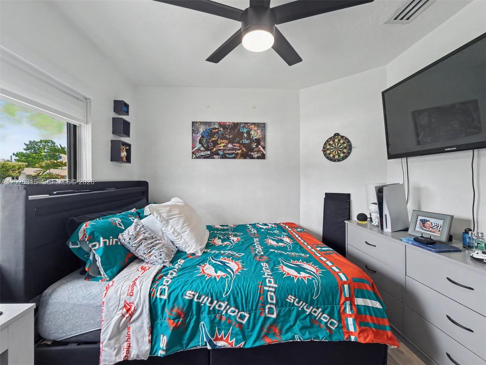 10762 Southwest 145th Street Miami, FL 33176 - Photo 13 of 28 a bedroom with a bed and flat screen tv