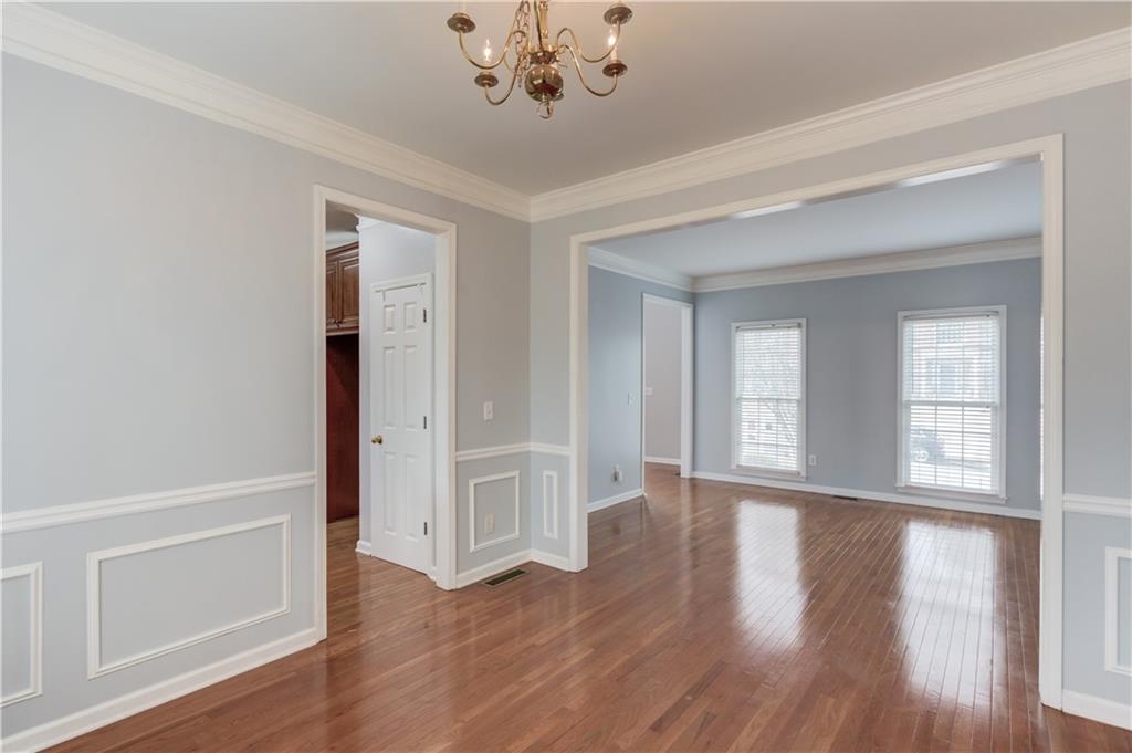 1446 Chadwick Ridge Court Lawrenceville, GA 30043 - Photo 11 of 54 a view of an empty room with wooden floor and a window