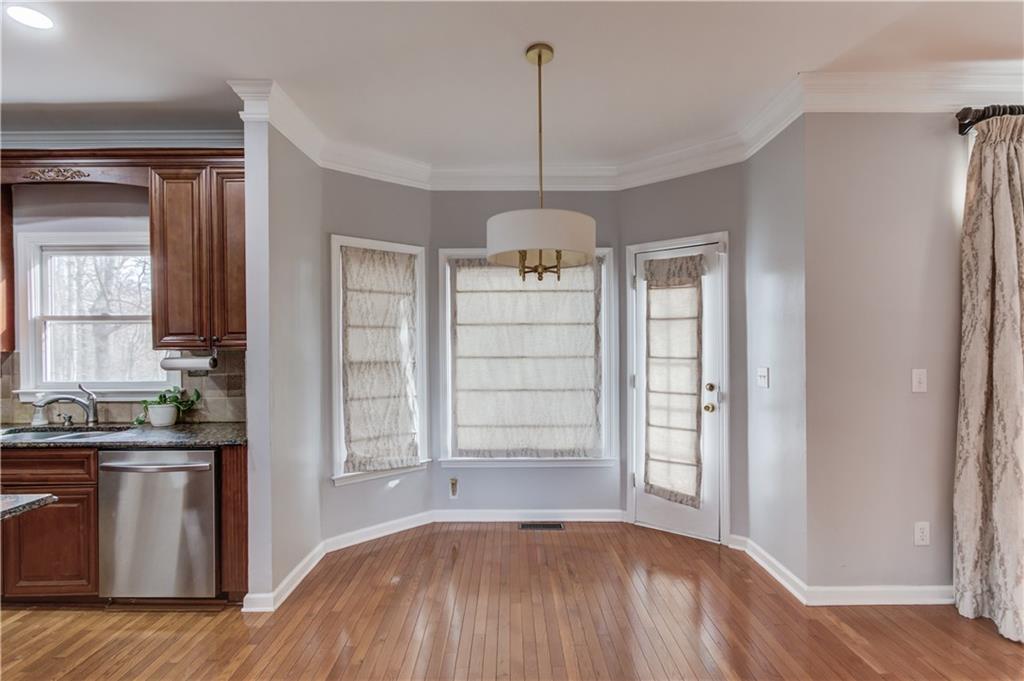 1446 Chadwick Ridge Court Lawrenceville, GA 30043 - Photo 16 of 54 a view of a kitchen with a sink and dishwasher area with wooden floor