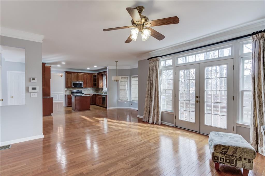 1446 Chadwick Ridge Court Lawrenceville, GA 30043 - Photo 18 of 54 a view of a livingroom with furniture a ceiling fan and wooden floor
