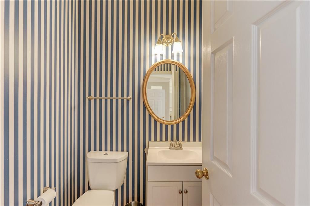 1446 Chadwick Ridge Court Lawrenceville, GA 30043 - Photo 19 of 54 a bathroom with a toilet a sink and a window