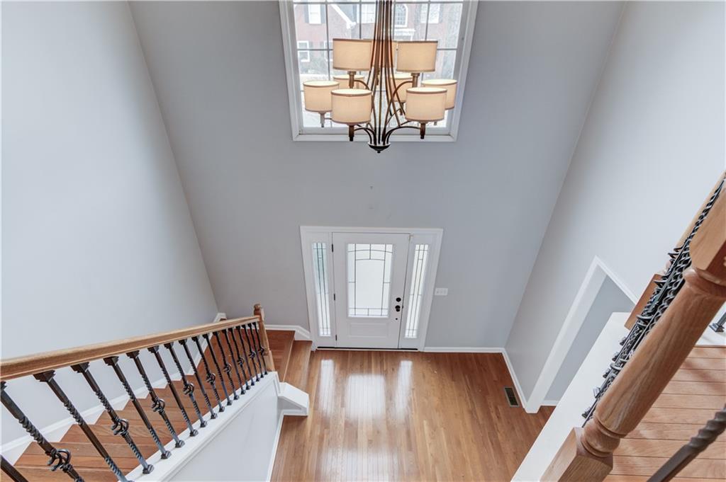 1446 Chadwick Ridge Court Lawrenceville, GA 30043 - Photo 20 of 54 a view of a hallway with wooden floor and staircase