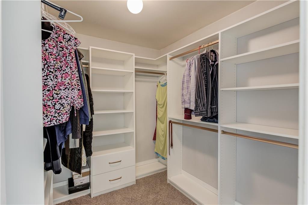 1446 Chadwick Ridge Court Lawrenceville, GA 30043 - Photo 27 of 54 a view of walk in closet with clothes and shoes