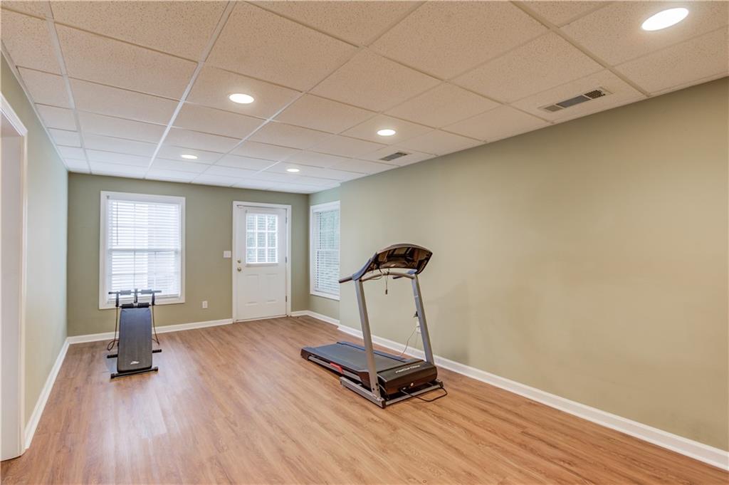 1446 Chadwick Ridge Court Lawrenceville, GA 30043 - Photo 36 of 54 a view of empty room with a window and wooden floor