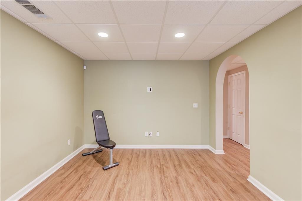 1446 Chadwick Ridge Court Lawrenceville, GA 30043 - Photo 37 of 54 a view of a room with wooden floor and windows