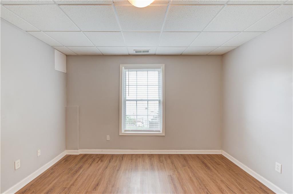 1446 Chadwick Ridge Court Lawrenceville, GA 30043 - Photo 38 of 54 a view of an empty room with wooden floor and a window