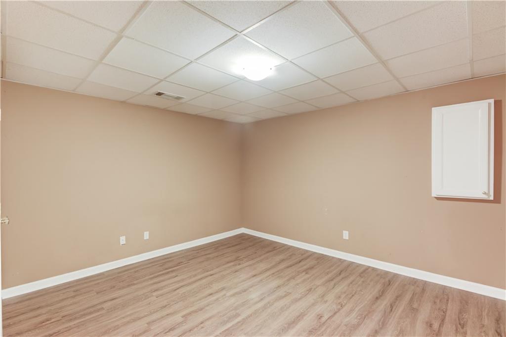 1446 Chadwick Ridge Court Lawrenceville, GA 30043 - Photo 41 of 54 a view of an empty room with wooden floor