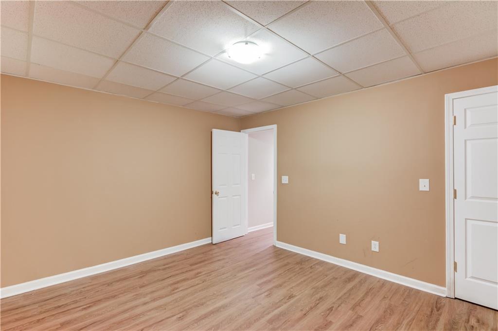 1446 Chadwick Ridge Court Lawrenceville, GA 30043 - Photo 42 of 54 a view of an empty room with wooden floor