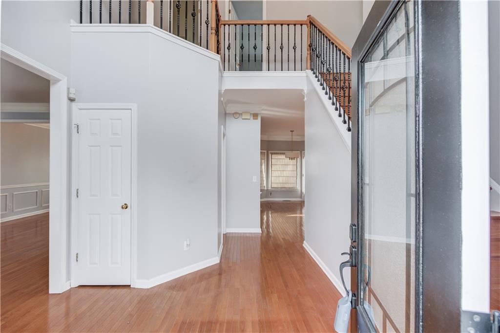 1446 Chadwick Ridge Court Lawrenceville, GA 30043 - Photo 5 of 54 a view of a hallway with wooden floor and staircase