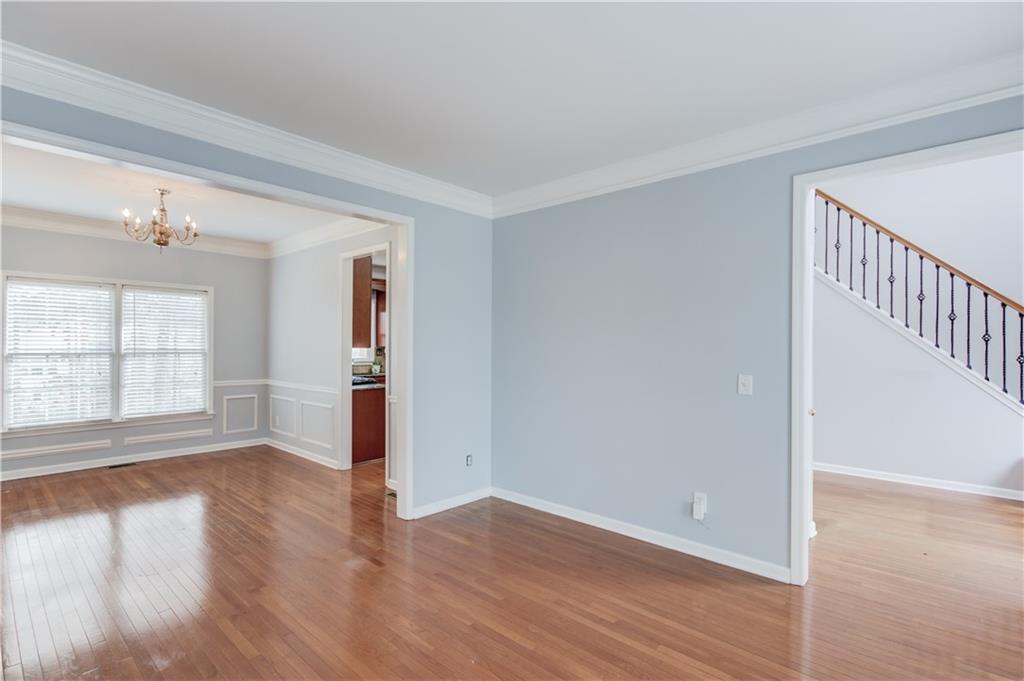 1446 Chadwick Ridge Court Lawrenceville, GA 30043 - Photo 8 of 54 wooden floor in an empty room with a window